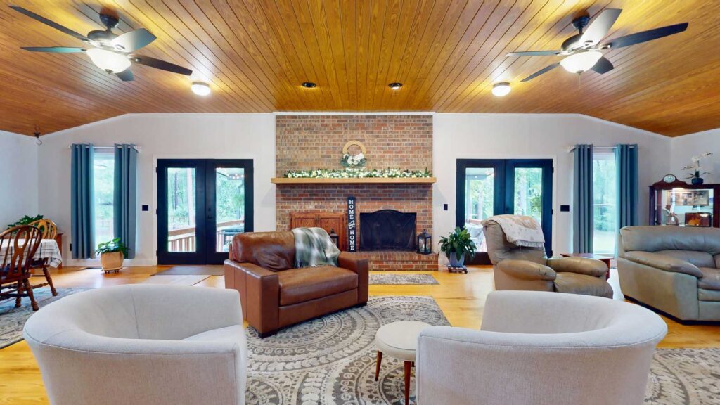 Living room with wood ceiling and brick fireplace at 103 Plantation Lane