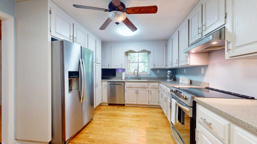 White kitchen with stainless steel appliances at 103 Plantation Lane
