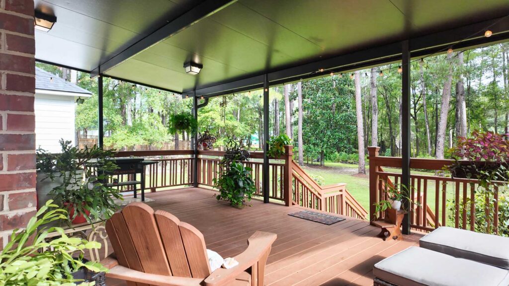 Covered back deck overlooking the wooded property
